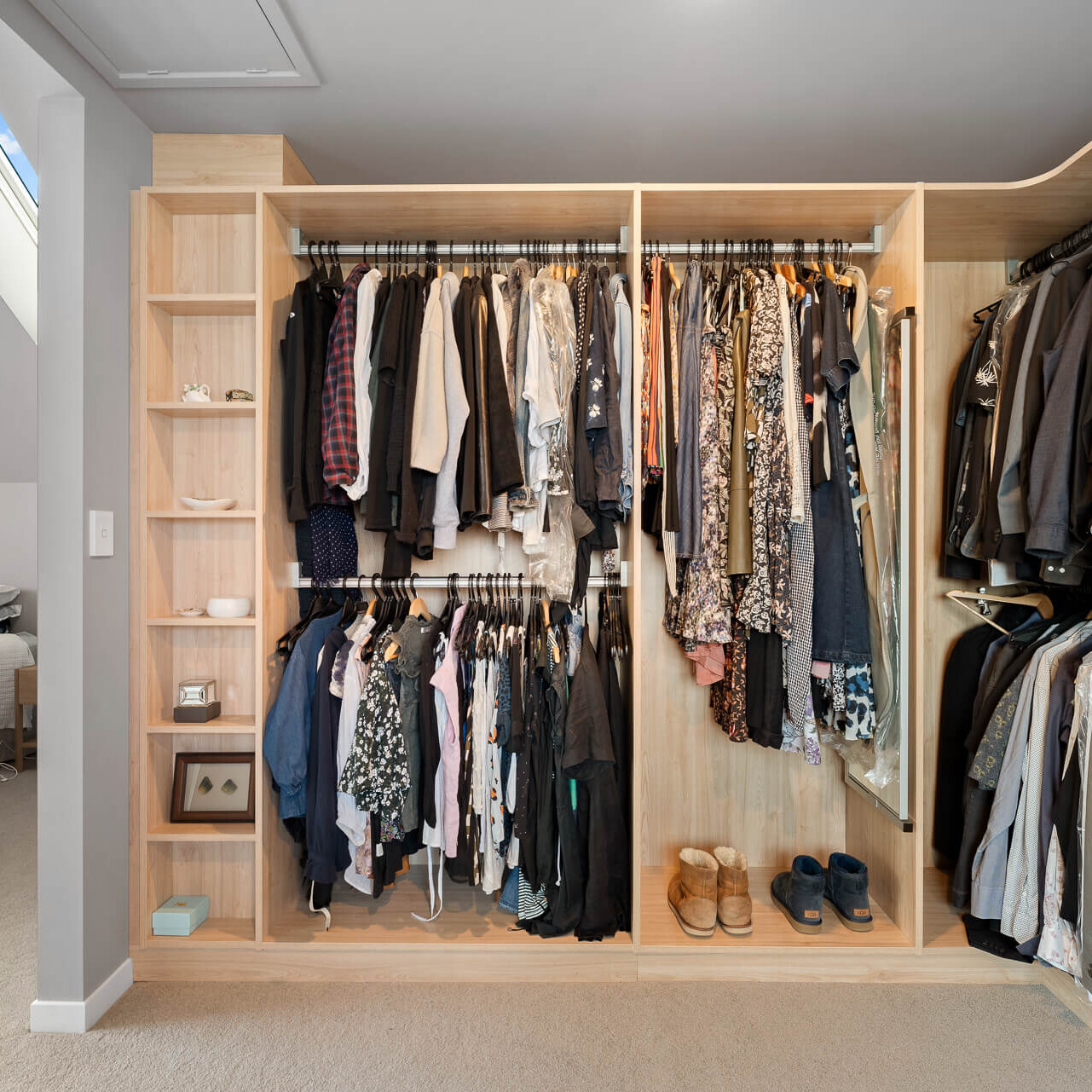 Luxe walk-in wardrobe organiser in light woodgrain colour, hanging space