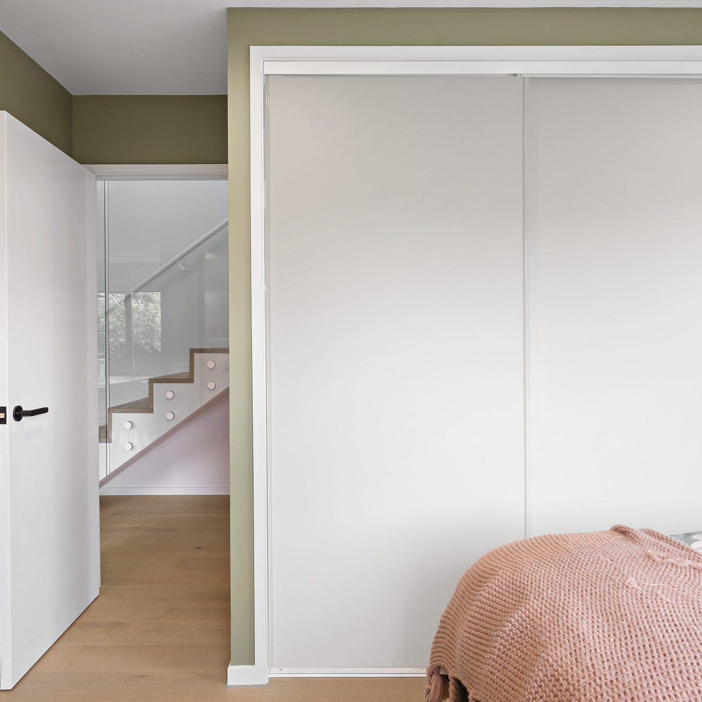 Bedroom showing White Aristo sliding wardrobe doors, closed