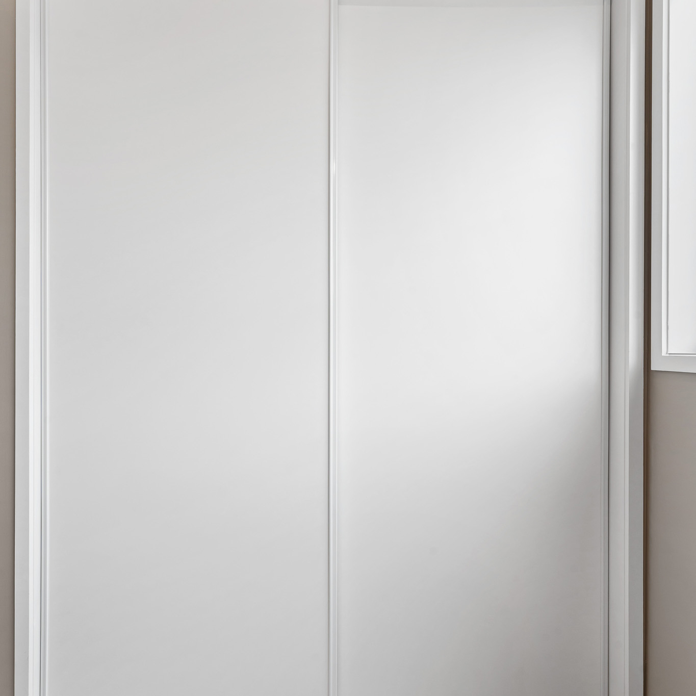 White Aristo sliding wardrobe doors, closed
