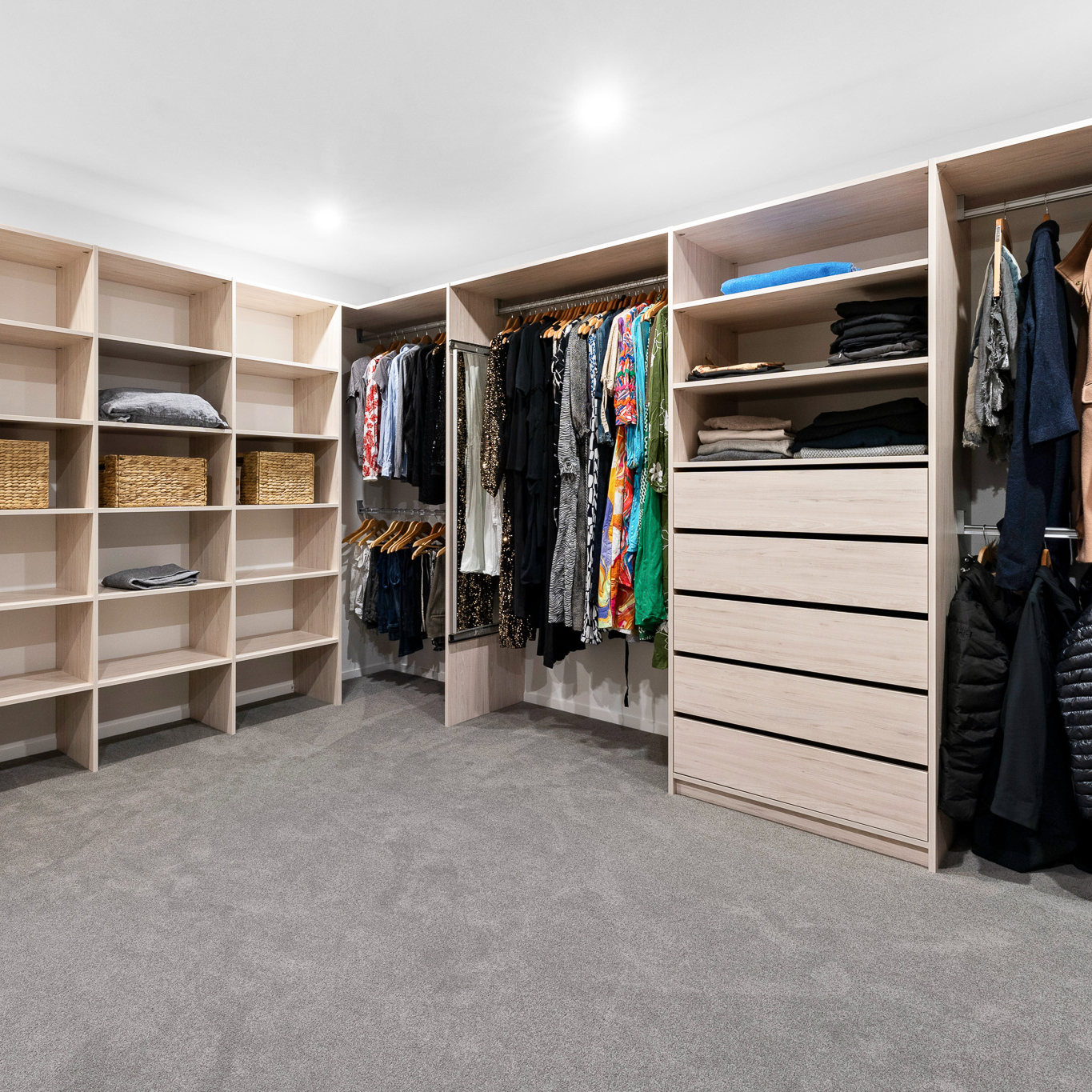 Flex walk-in wardrobe organiser in light woodgrain colour, wide shot showing the whole space which is large