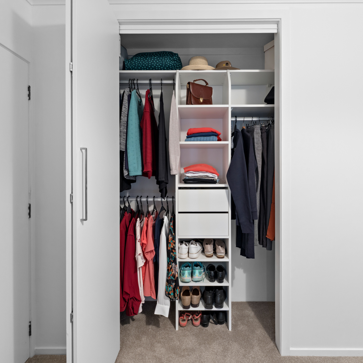 Custom wardrobe with multiple compartments and hanging space for clothing and accessories.